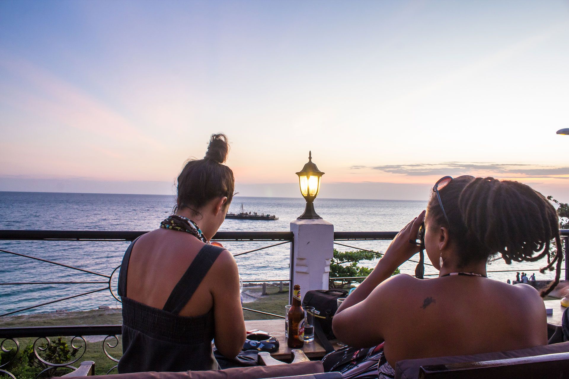 Tourists enjoy the sunset at a hotel in Stone Town, Zanzibar
