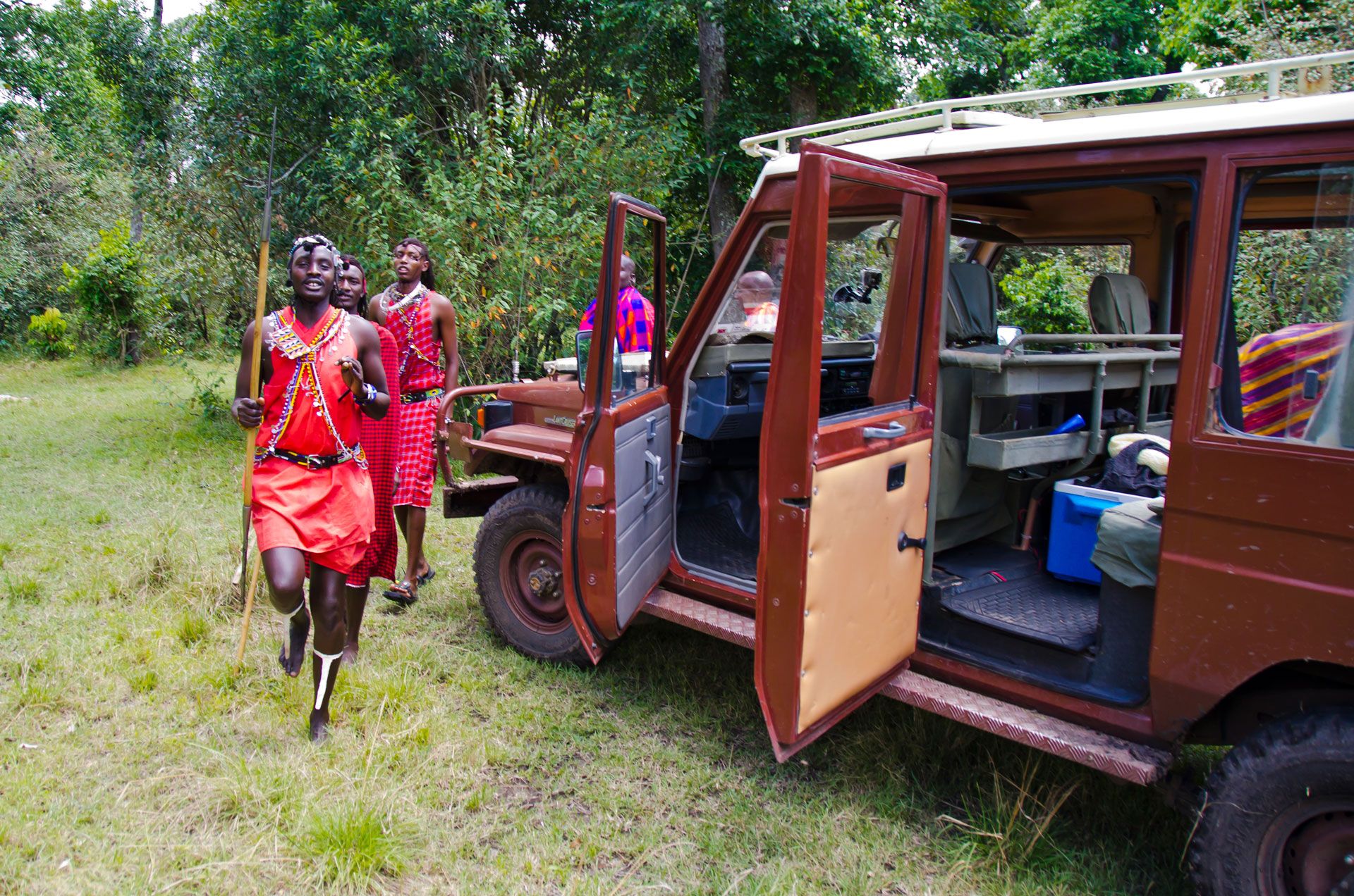 Maasai morans welcome guests to a safari camp in the Maasai Mara