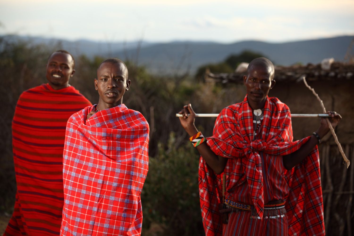 Maasai morans outside a village hut
