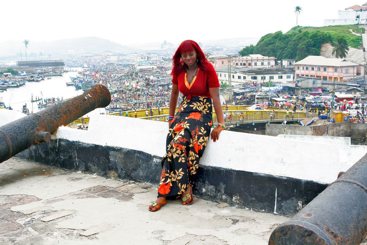 A tourist poses for a photo at Elmina Castle in Ghana.