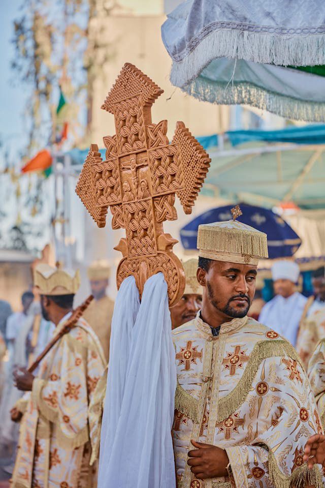 Man carries a cross during a religious festival